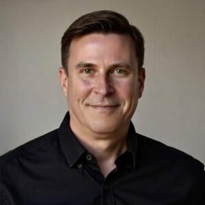 Headshot of Cape Town Opera Librettist in Residence Alan Olejniczak in a black shirt.
